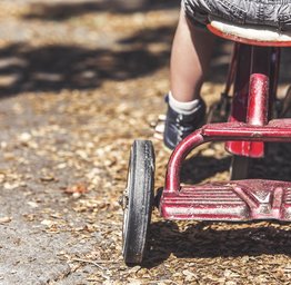 kid riding a tricycle