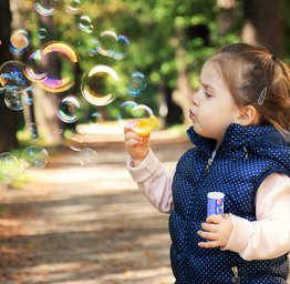kid blowing bubbles